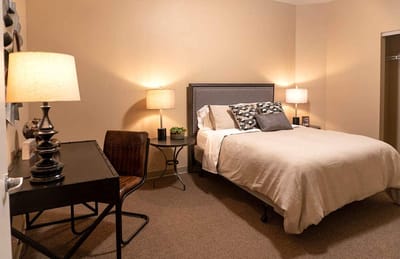 Cozy bedroom featuring a bed and workspace