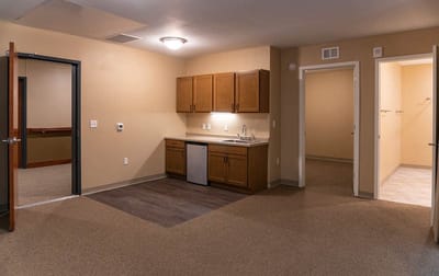 Interior view of a resident's room with kitchenette