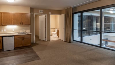 Interior view of a resident's room with kitchenette