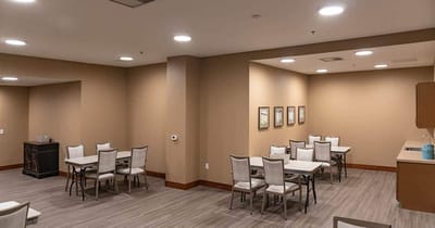 A bright common area with tables and chairs