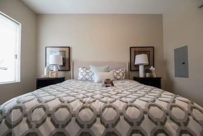 Cozy bedroom setup with decorative bedding and lamps