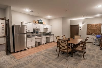 Bright communal kitchen area with dining table