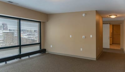 A spacious interior room with large windows