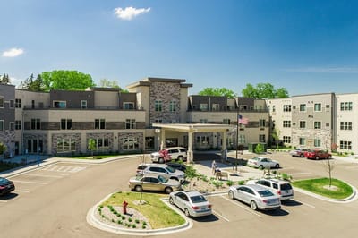 Exterior view of Havenwood Of Minnetonka with residents and vehicles