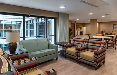 Bright lounge area with striped chairs and natural light