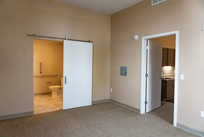 Bright interior view of a resident room with bathroom