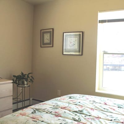 Cozy resident room with floral bedding and natural light