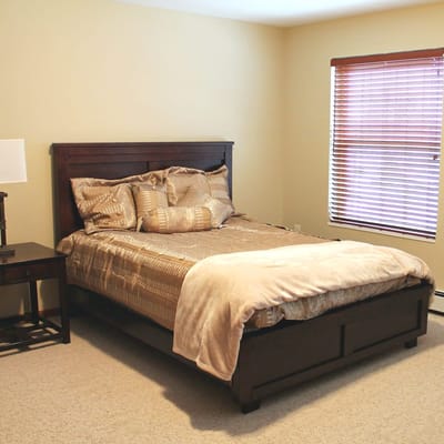 Cozy bedroom with a queen-sized bed and window shades