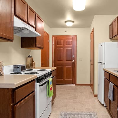 Bright kitchen area with cabinets and appliances