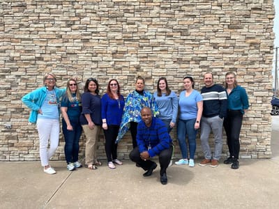 Staff members posing outside the facility