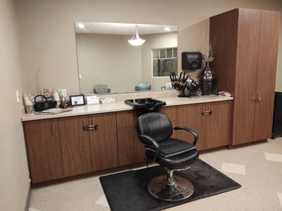 Hair salon area with a styling chair and vanity