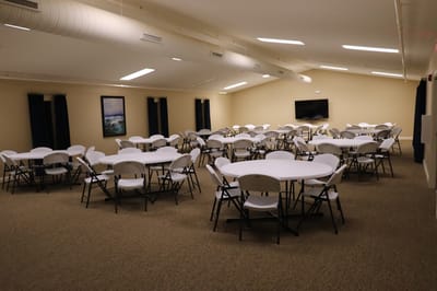 Interior view of a spacious activity room with tables