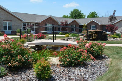 Beautifully landscaped courtyard with flowers and a bridge