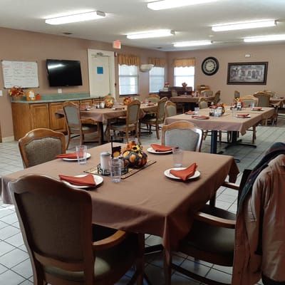 Dining area set up for a meal with tables and decor