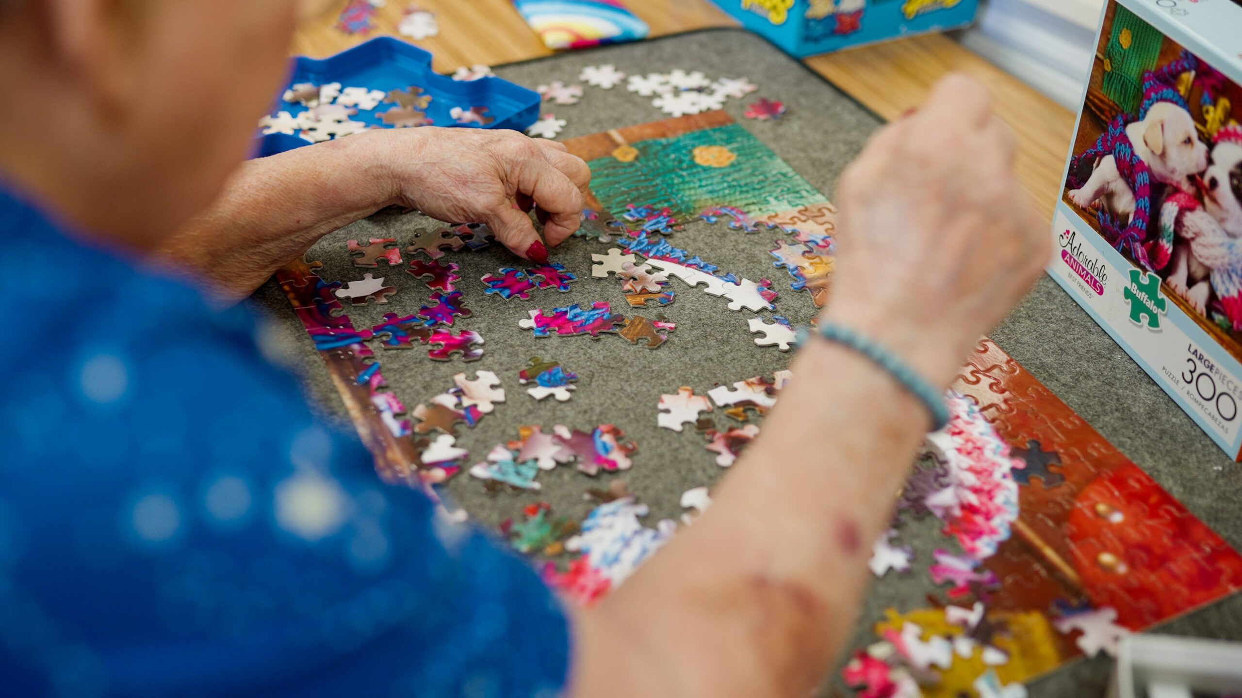 A resident assembling a colorful jigsaw puzzle