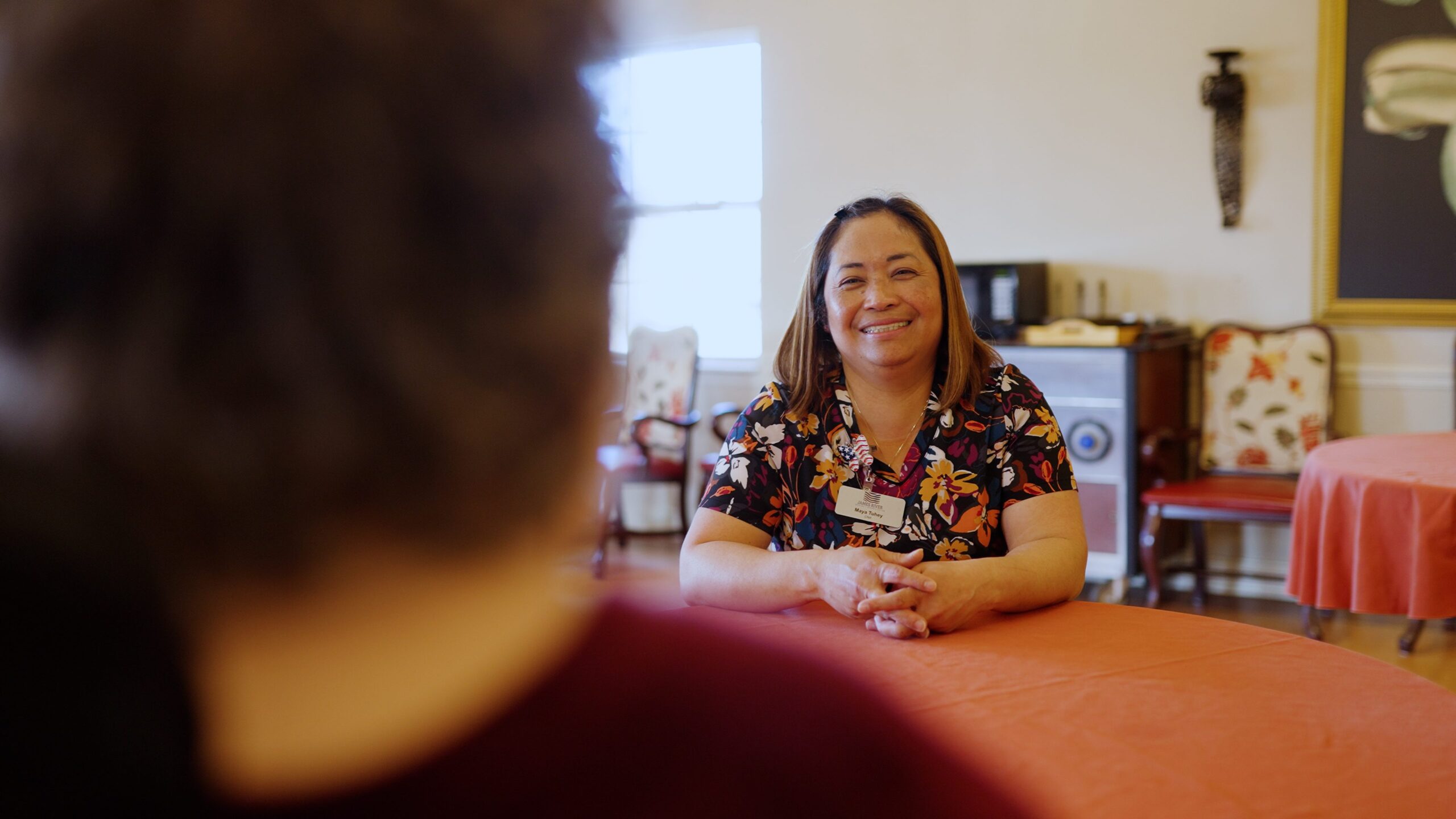 Staff member smiling in a common area