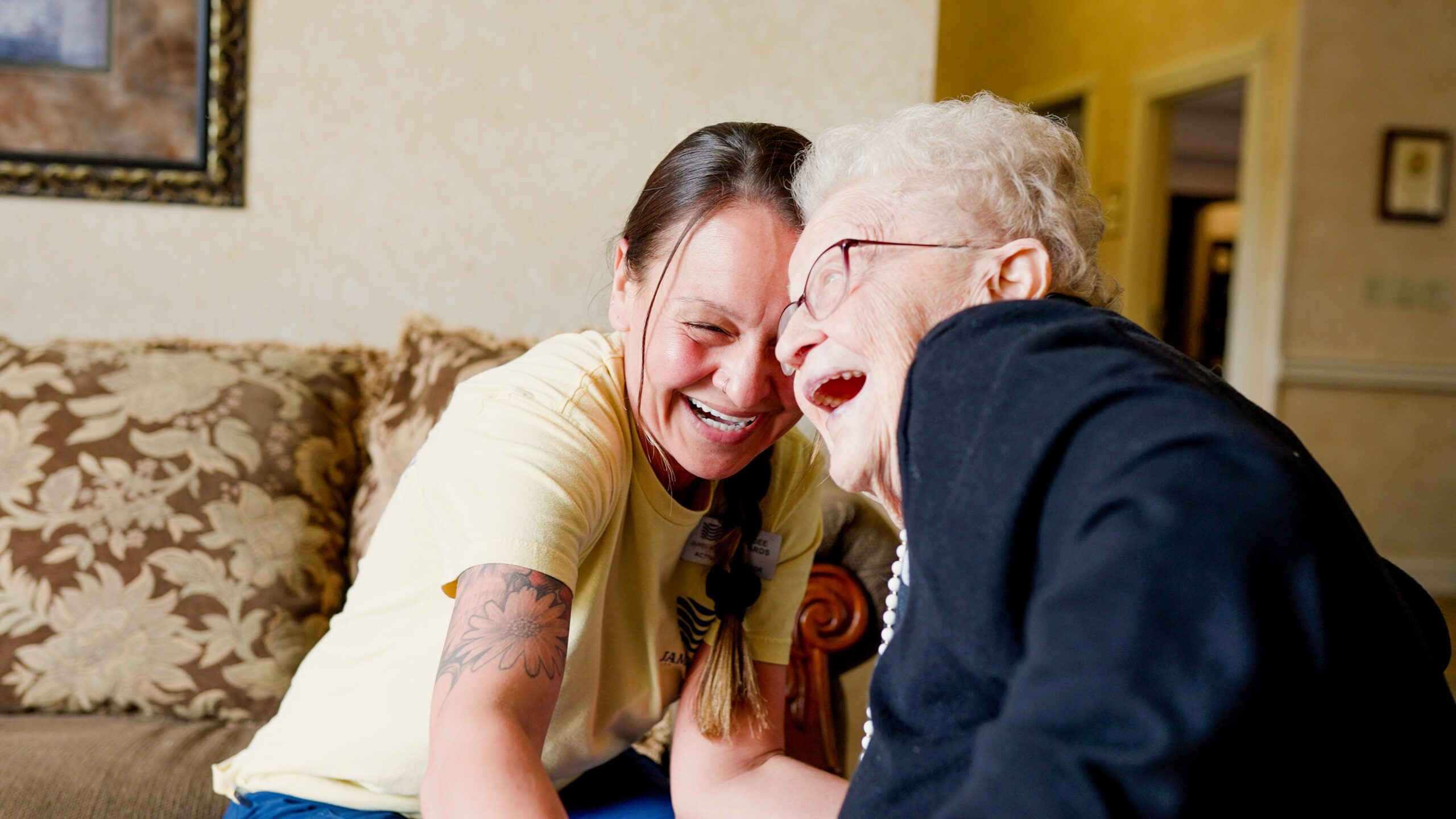 Staff member sharing a joyful moment with a resident