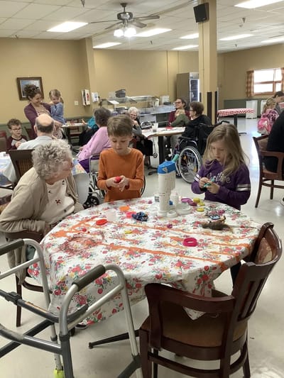 Residents engaging in a craft activity in a common area.