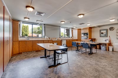 Bright interior kitchen space with tables and appliances