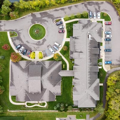 Aerial view of the facility with landscaped grounds and parking