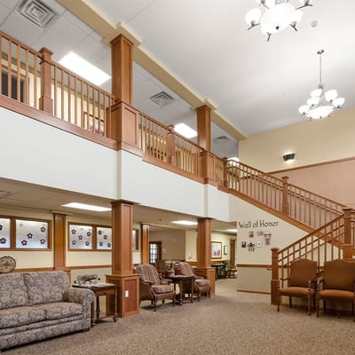 Common area with seating and staircase in a senior living facility