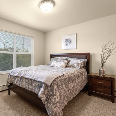 Bright and cozy resident room with a bed and decorative accents