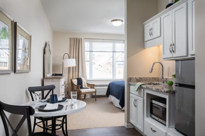 Cozy resident room with kitchenette and seating area