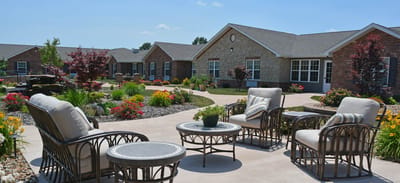 Outdoor seating area surrounded by gardens