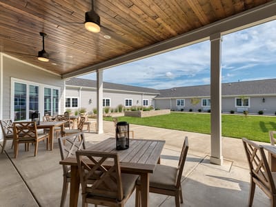 Outdoor patio with seating area overlooking green space