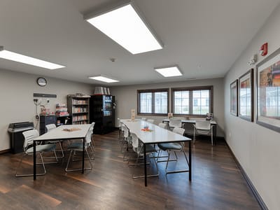 Bright activity room with tables and shelves
