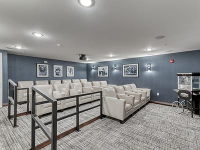 Interior theater room with seating and decorative photos