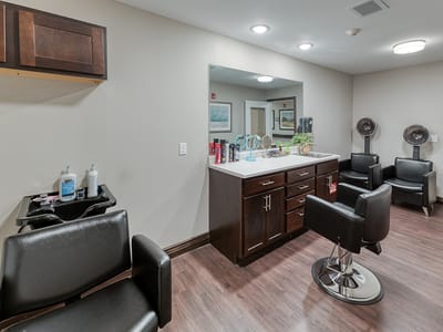 Hair salon area with styling chairs and mirrors