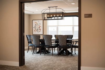 A private dining room with a large table and elegant lighting