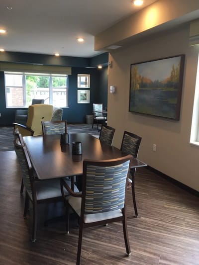 Bright common area with seating and a dining table