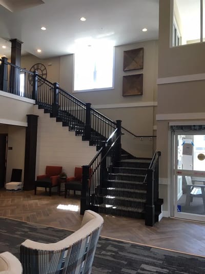 Interior view of a lobby area with stairs and seating