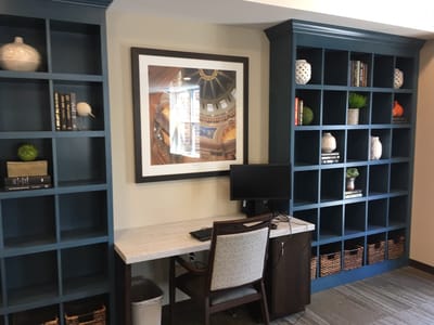 Cozy common area with shelves and computer station