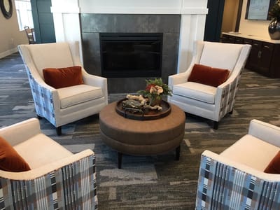 Cozy common area with chairs and fireplace