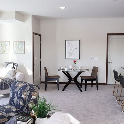 Bright interior of a resident room with table and chairs