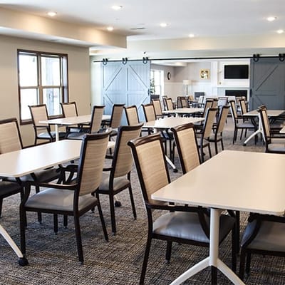 Bright common area with organized tables and chairs