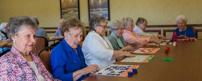 Residents enjoying a bingo game in a common area