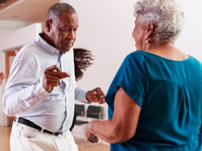 Residents dancing in a lively activity room