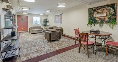 Common area with seating and decorations in a senior living facility