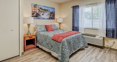 Cozy resident room with a bed and window.