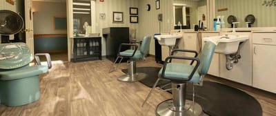 Interior view of a beauty salon area with styling chairs
