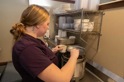 Staff member preparing meal in the kitchen
