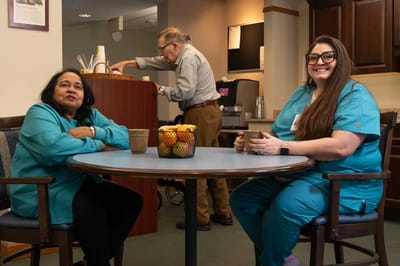 Two staff members in a common area at the facility