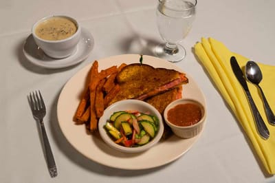 A plate of food with sweet potato fries and salad
