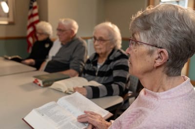 Residents engaged in reading during an activity session