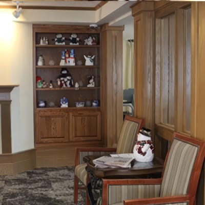 Cozy common area with seating and a decorative shelf