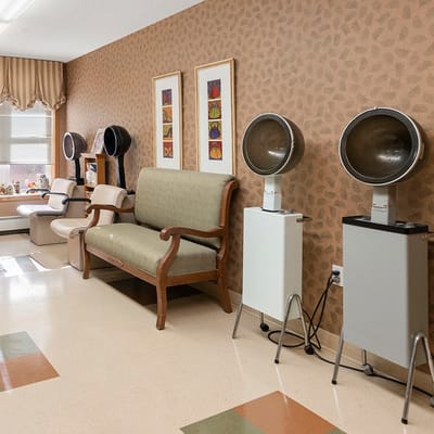 Interior salon area with hairdryers and seating